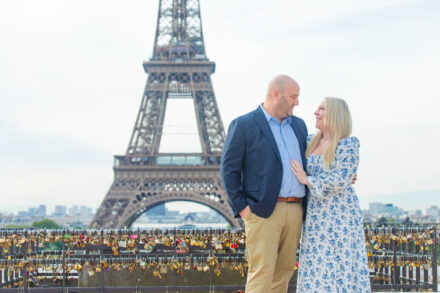 Katie and Dan posing in front of the Eiffel Tower during their Eiffel Tower photoshoot in Paris